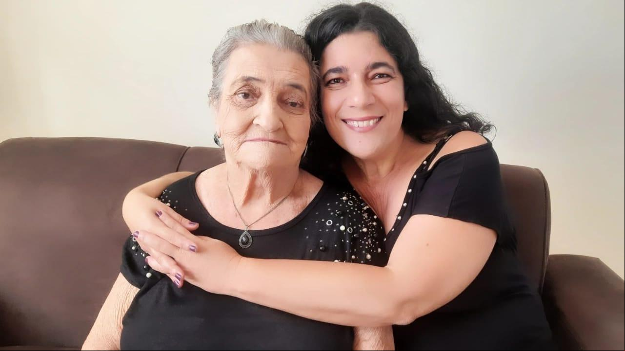 A auxiliar istrativa Sandra Calazans abraçada à mãe: ela e os irmãos montaram um esquema de revezamento para cuidar da idosa